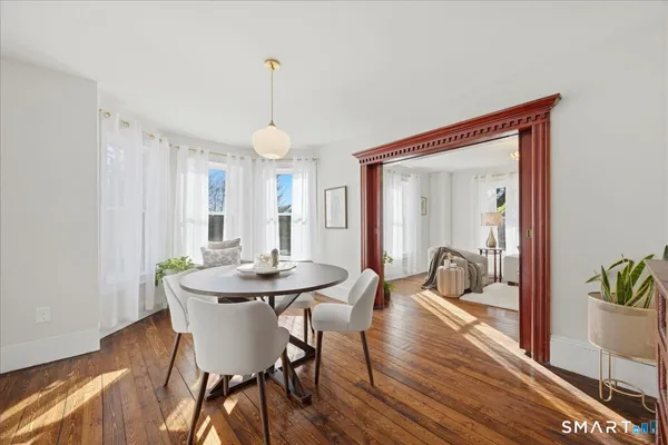 a view of a dining room with furniture window and wooden floor
