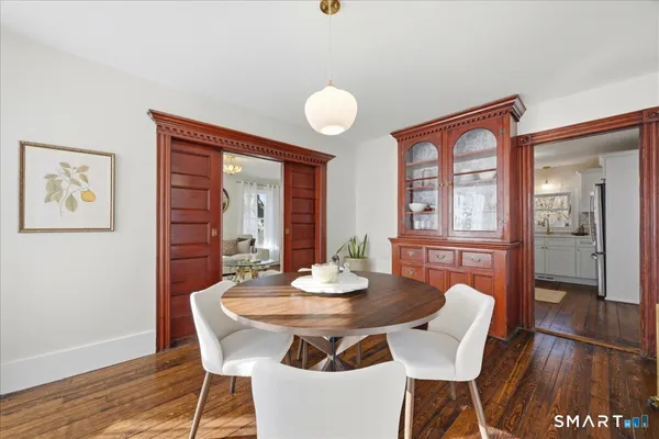 a view of a dining room with furniture wooden floor and a rug
