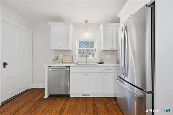 a kitchen with stainless steel appliances granite countertop a stove a sink and a refrigerator