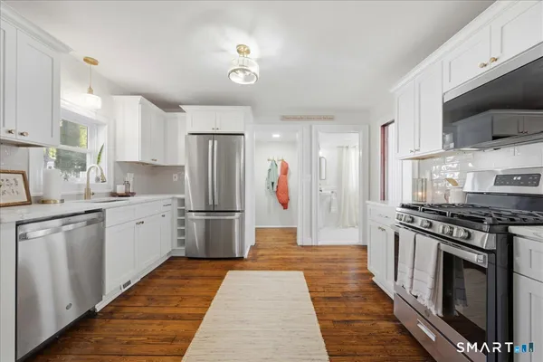 a kitchen with a sink and a stove top oven