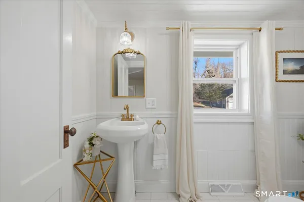 a bathroom with a toilet a sink and tub