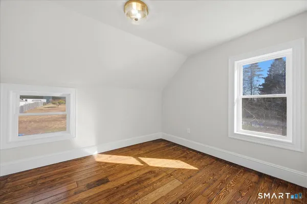 a view of a room with wooden floor
