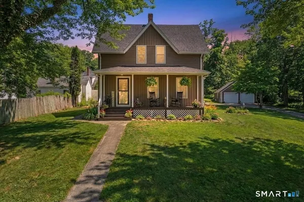a front view of house with yard and green space