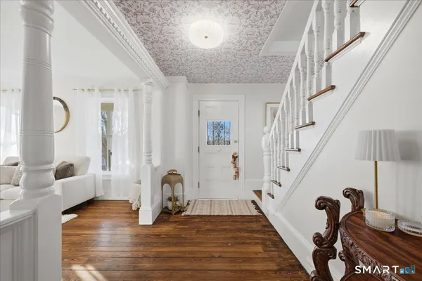 a view of an entryway with wooden floor