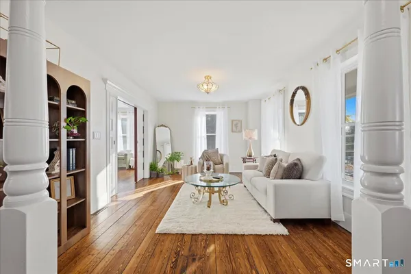 a living room with furniture and a wooden floor
