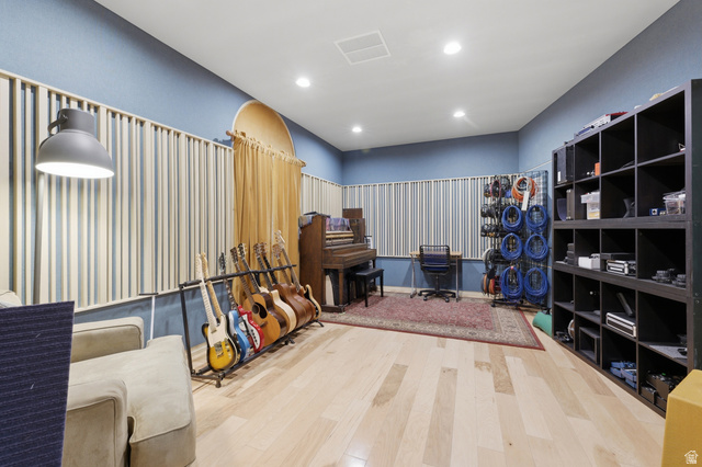 702 Alpine Highway Alpine, UT 84004 - Photo 65 of 83 Recessed lighting illuminates a room featuring horizontal acoustic paneling, light wood-finish flooring, and a built-in shelving unit