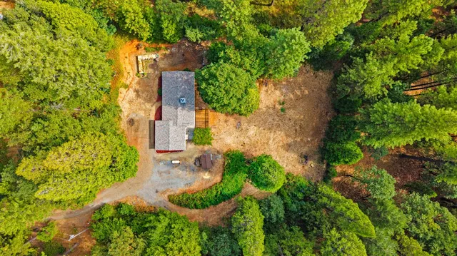 an aerial view of a house with a yard