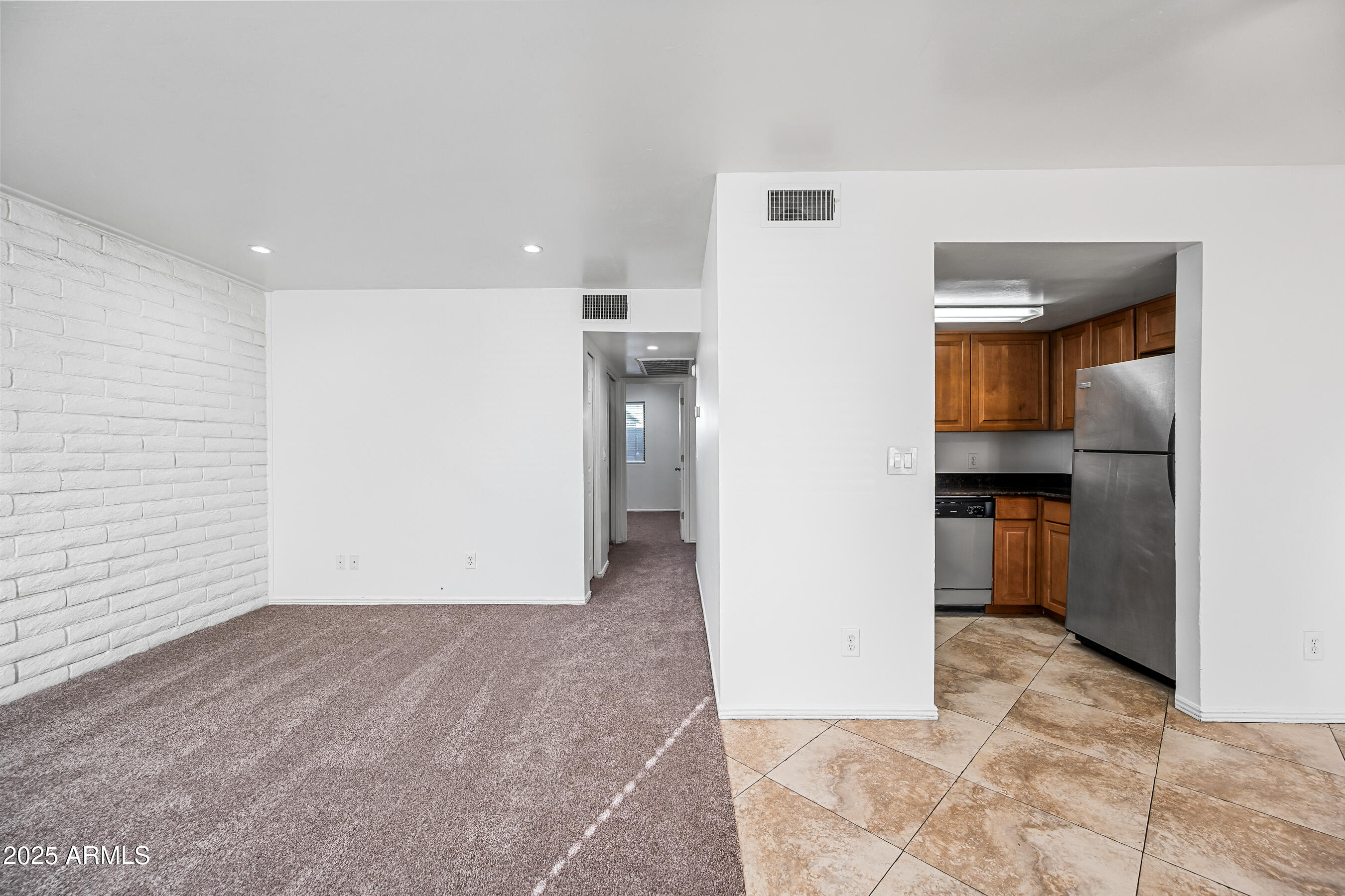 1234 North 36th Street, Unit 109 Phoenix, AZ 85008 - Photo 2 of 16 a view of a hallway with wooden floor and a kitchen