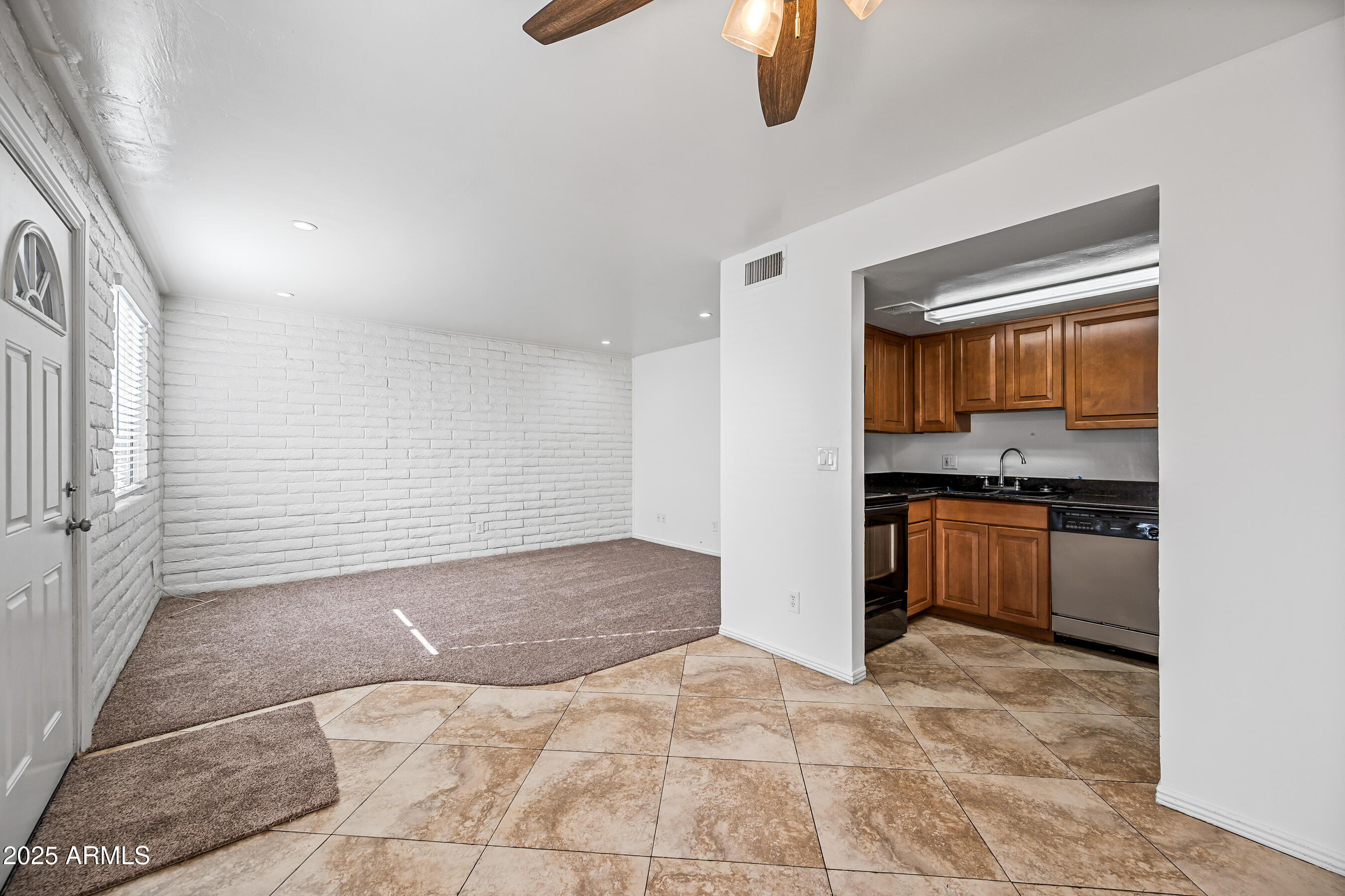 1234 North 36th Street, Unit 109 Phoenix, AZ 85008 - Photo 6 of 16 a view of a kitchen with a sink and dishwasher cabinets