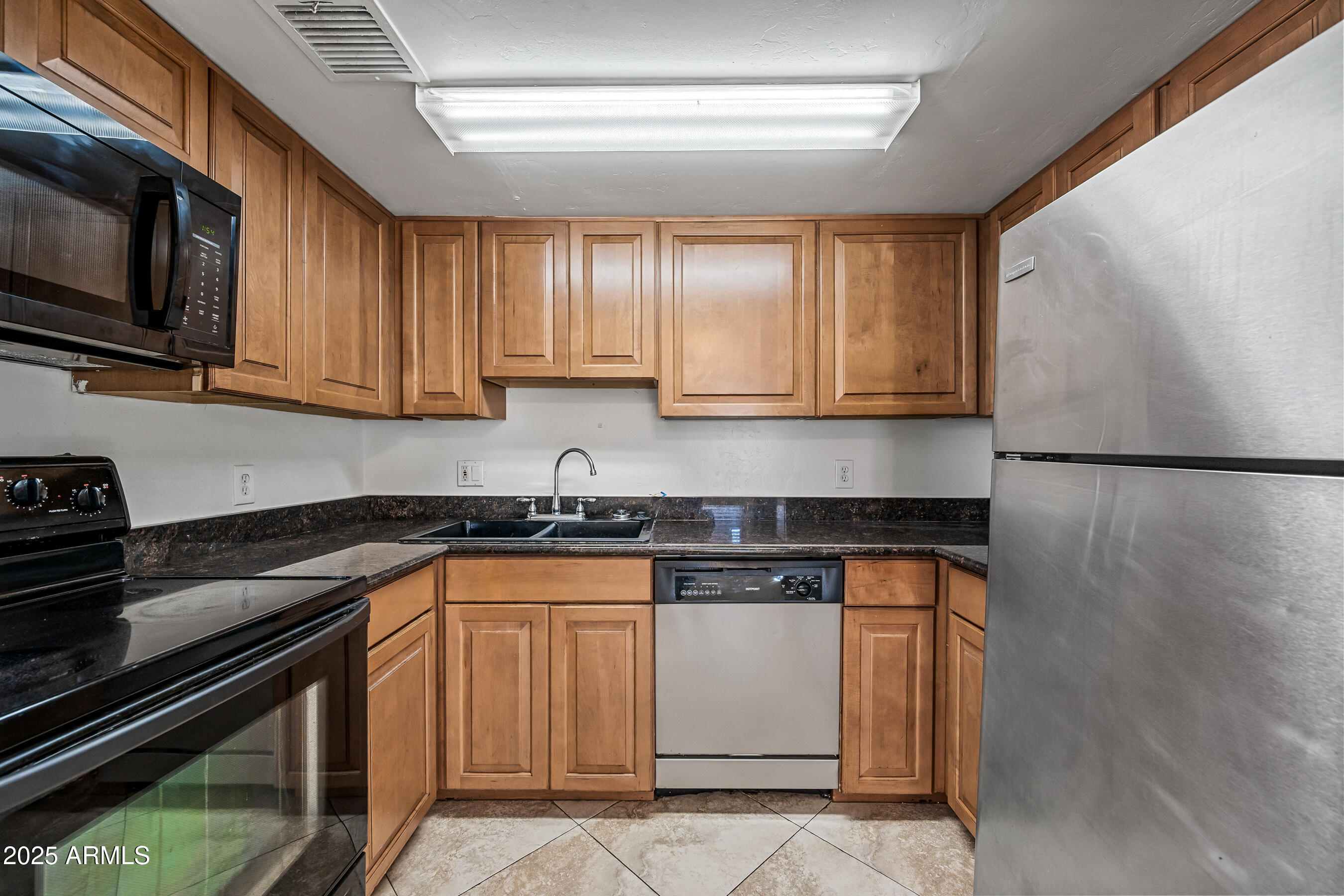 1234 North 36th Street, Unit 109 Phoenix, AZ 85008 - Photo 7 of 16 a kitchen with stainless steel appliances granite countertop a sink stove and microwave