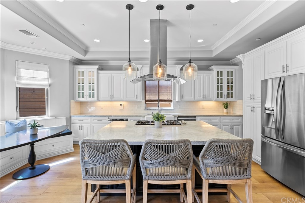 2210 Robinson Street Redondo Beach, CA 90278 - Photo 10 of 39 a kitchen with a table chairs stove and kitchen island
