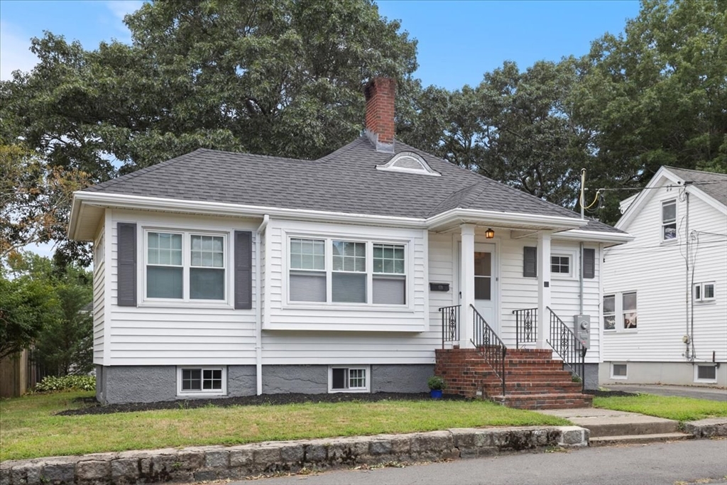 a front view of a house with a garden