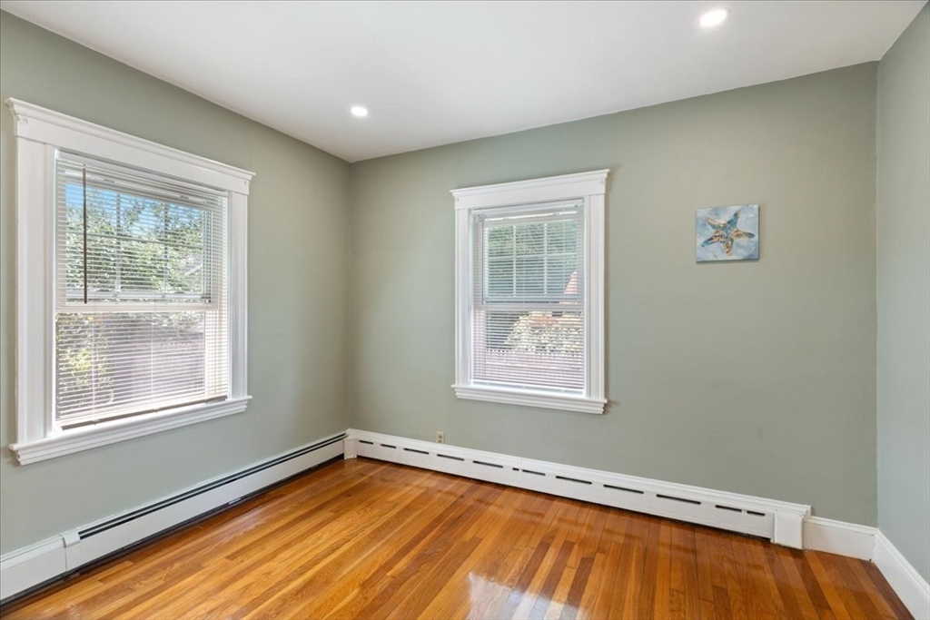 40 Riverview Street Dedham, MA 02026 - Photo 11 of 22 a view of an empty room with a window and wooden floor