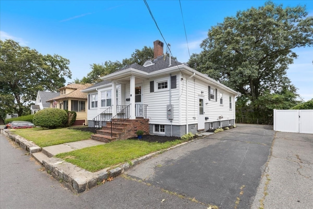 40 Riverview Street Dedham, MA 02026 - Photo 17 of 22 a front view of a house with a yard