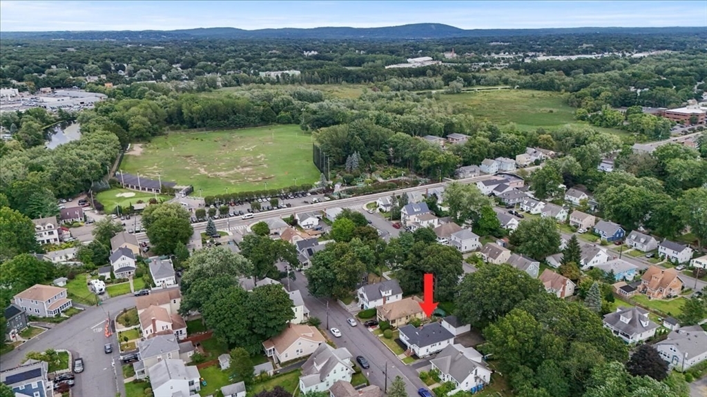 40 Riverview Street Dedham, MA 02026 - Photo 2 of 22 an aerial view of green landscape with trees houses and mountain view