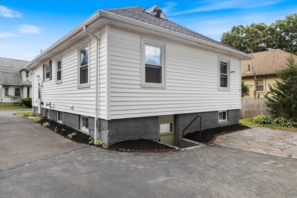40 Riverview Street Dedham, MA 02026 - Photo 21 of 22 a view of a house with a yard and garage
