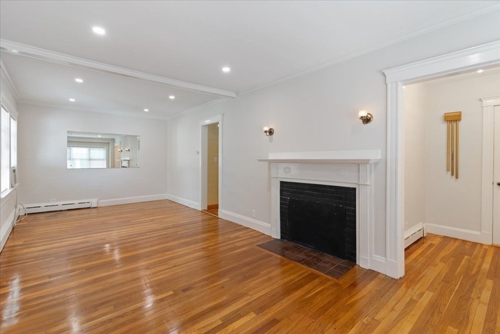 40 Riverview Street Dedham, MA 02026 - Photo 4 of 22 a view of an empty room with wooden floor and a window