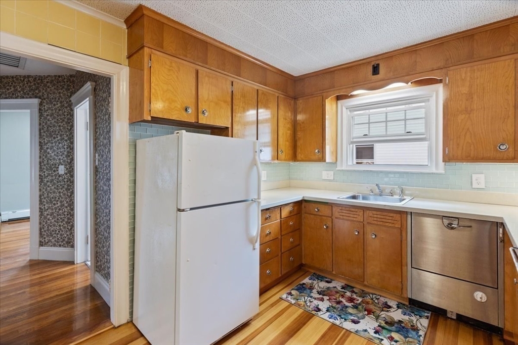 40 Riverview Street Dedham, MA 02026 - Photo 6 of 22 a kitchen with a refrigerator and a sink