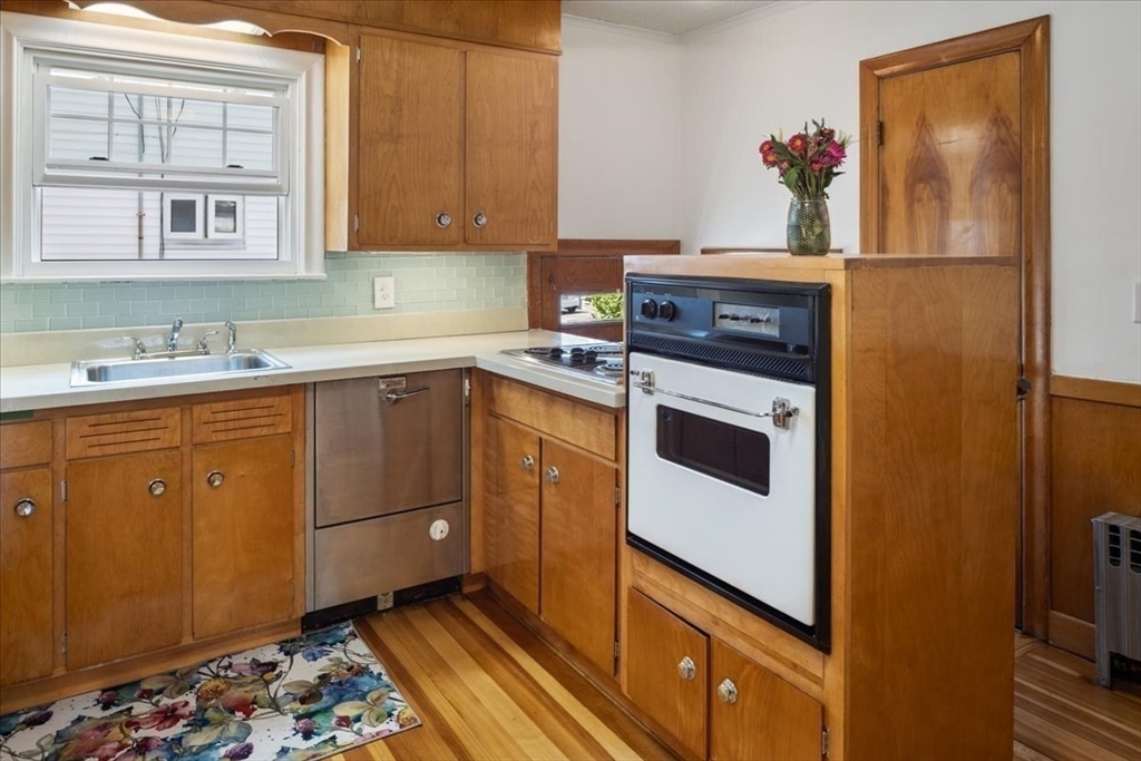 40 Riverview Street Dedham, MA 02026 - Photo 7 of 22 a kitchen with a stove and cabinets