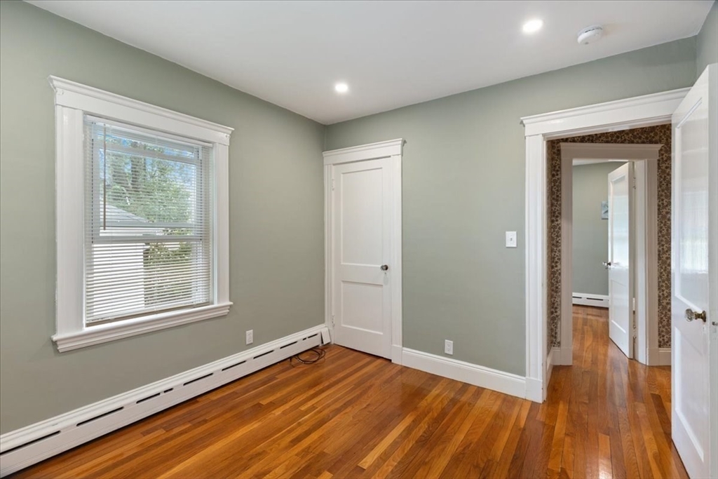 40 Riverview Street Dedham, MA 02026 - Photo 10 of 22 a view of an empty room with wooden floor and a window