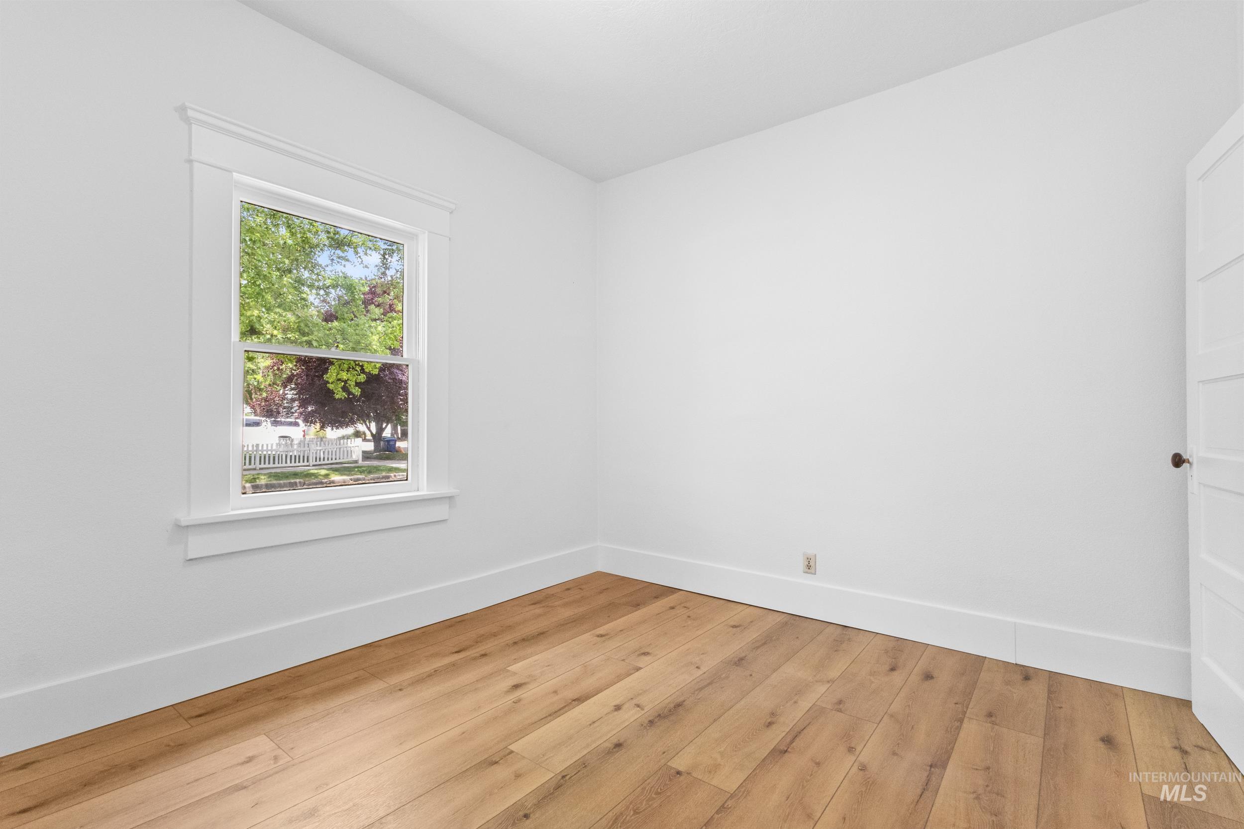 2119 West Brumback Street Boise, ID 83702 - Photo 20 of 30 Bright room featuring wood-finish flooring, crisp white walls, and a large window with white trim