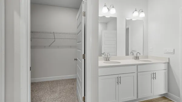 a bathroom with a double vanity sink and a mirror
