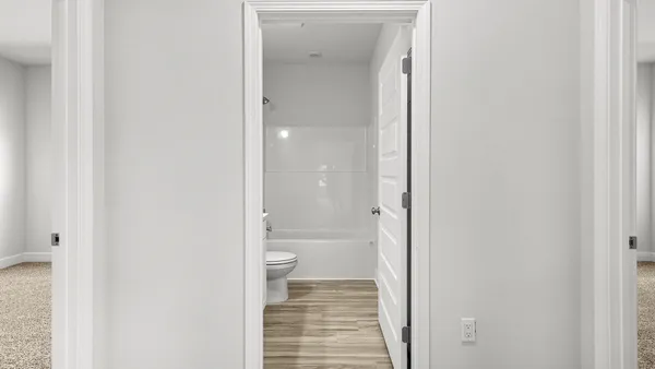 a bathroom with a granite countertop toilet and a shower