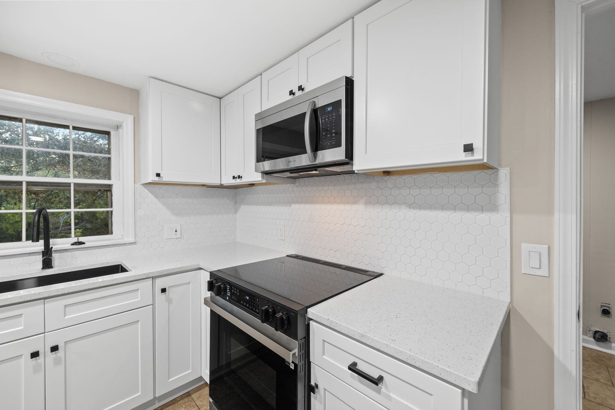 133 Mockerson Road Leoma, TN 38468 - Photo 14 of 33 a kitchen with white cabinets and appliances