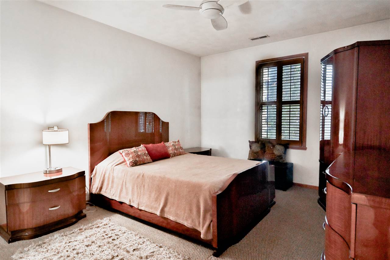 10135 Monarch Road, Unit 3 Roscoe, IL 61073 - Photo 12 of 20 a bedroom with a bed and wooden floor