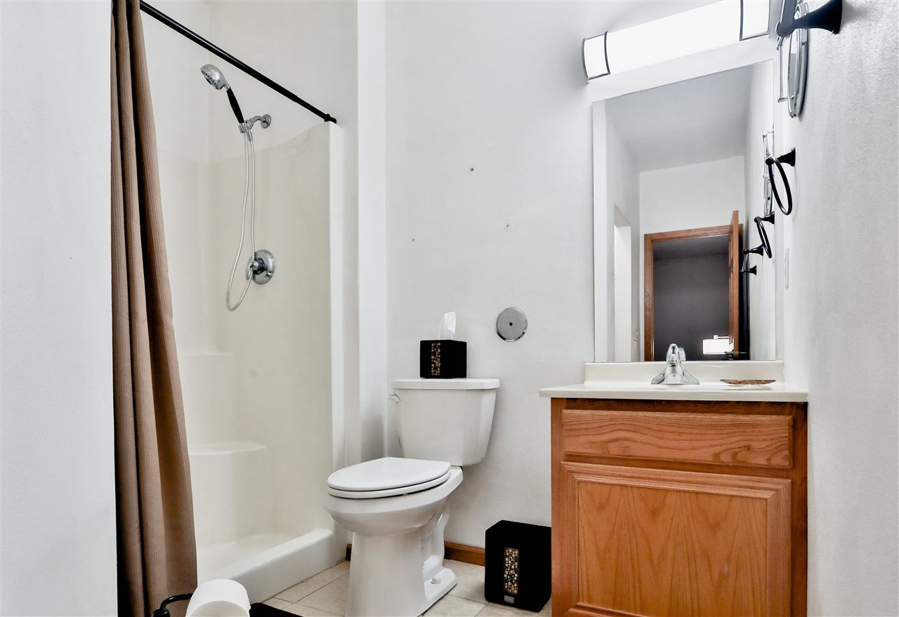 10135 Monarch Road, Unit 3 Roscoe, IL 61073 - Photo 14 of 20 a bathroom with a toilet a sink and a mirror