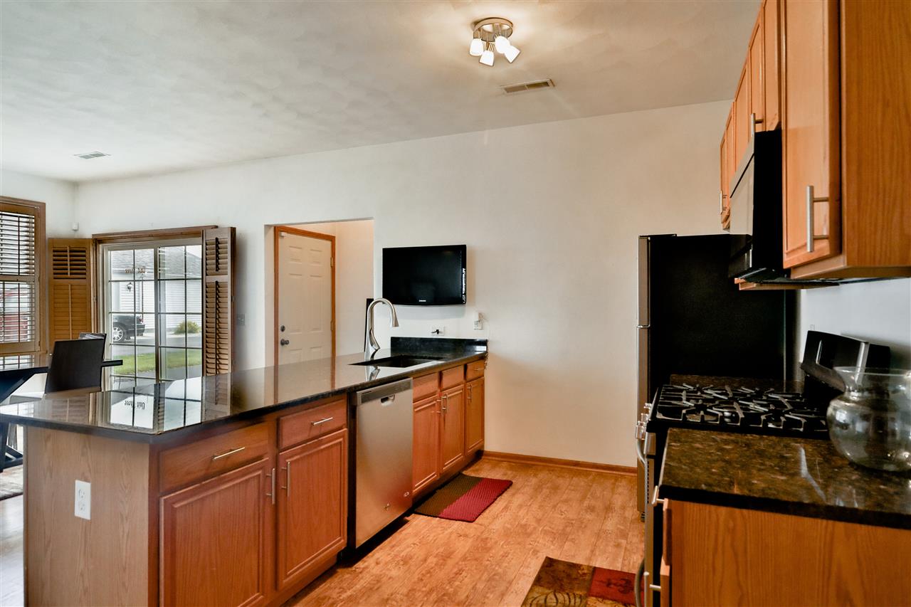 10135 Monarch Road, Unit 3 Roscoe, IL 61073 - Photo 10 of 20 a kitchen with stainless steel appliances granite countertop a stove and a sink