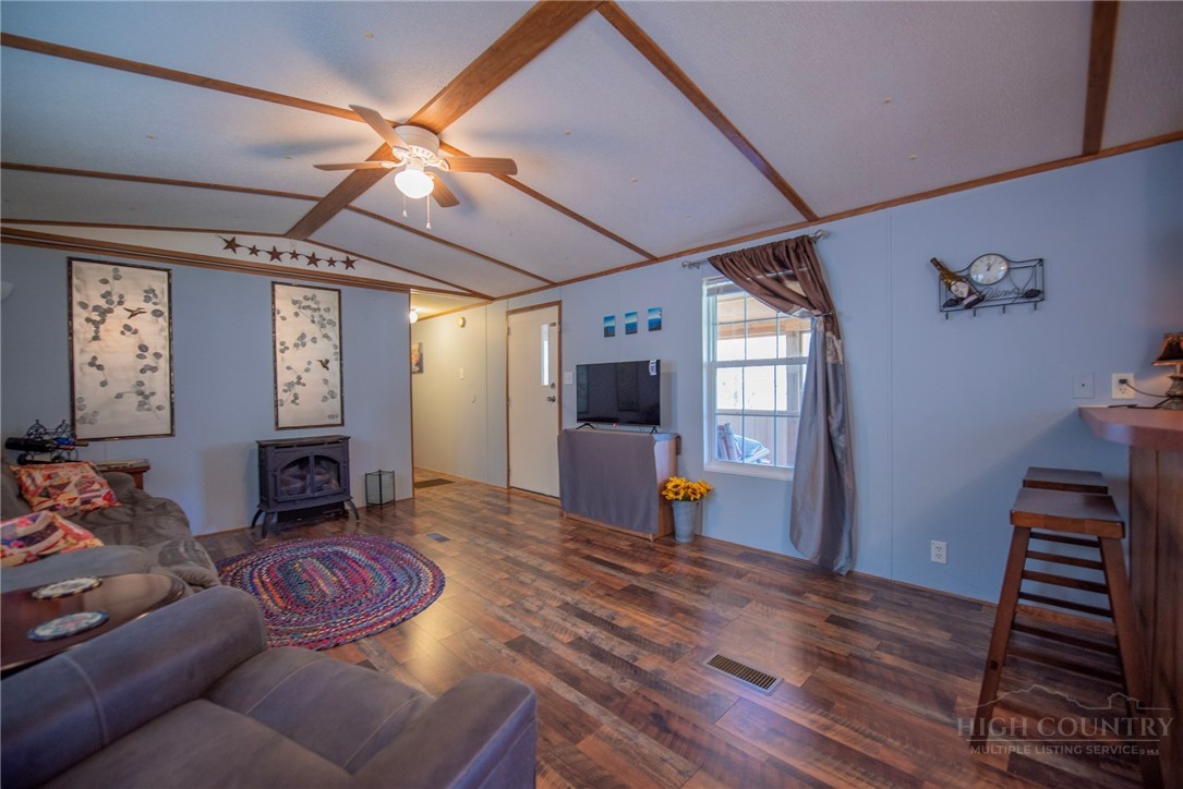 1848 West Mill Creek Road Warrensville, NC 28693 - Photo 14 of 50 a living room with furniture and a fireplace