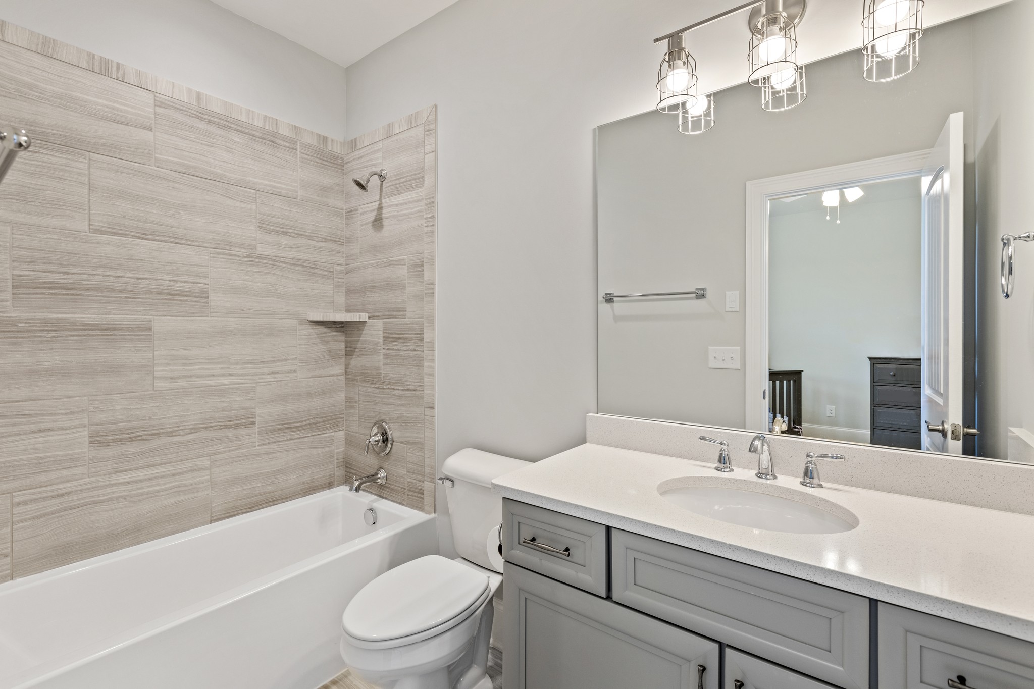7952 Daugherty-Capley Road Primm Springs, TN 38476 - Photo 30 of 44 a bathroom with a sink a toilet a mirror a bathtub and shower