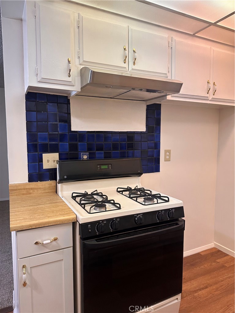 1350 West Lambert Road, Unit 120 La Habra, CA 90631 - Photo 11 of 22 a kitchen with a stove and a cabinets
