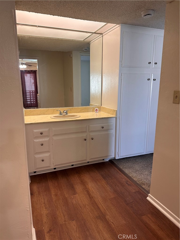 1350 West Lambert Road, Unit 120 La Habra, CA 90631 - Photo 9 of 22 a room with wooden floor and mirror