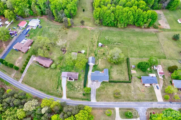 an aerial view of residential house with outdoor space and swimming pool