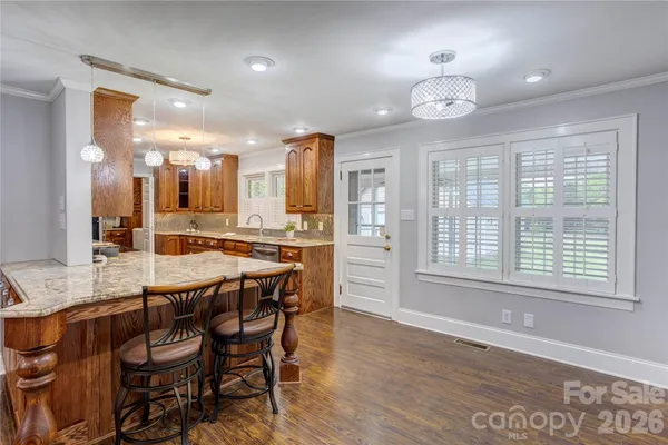 a large kitchen with a table and chairs