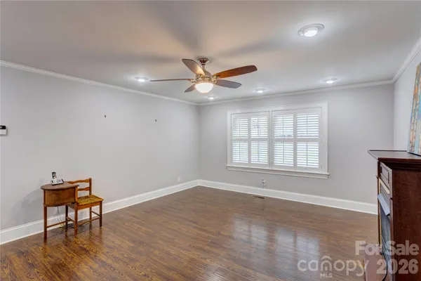 a view of workspace with wooden floor and a ceiling fan