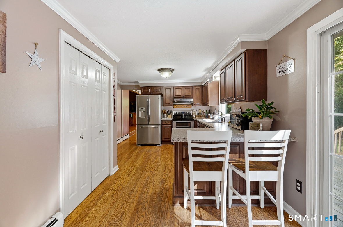 84 Christy Hill Road Ledyard, CT 06335 - Photo 8 of 27 a kitchen with a refrigerator and wooden floor