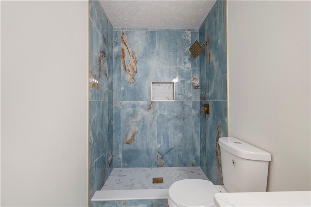766 Lee Road Phenix City, AL 36870 - Photo 15 of 30 Full bath with a shower stall and a textured ceiling