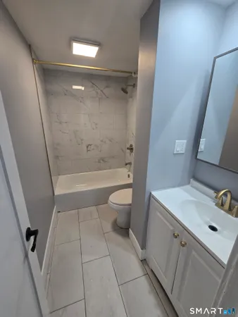 a kitchen with a refrigerator and white cabinets