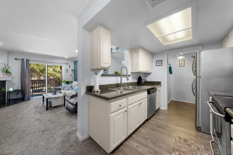 a large kitchen with stainless steel appliances granite countertop a sink stove microwave and refrigerator