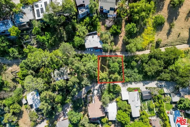 an aerial view of residential house with outdoor space and trees all around
