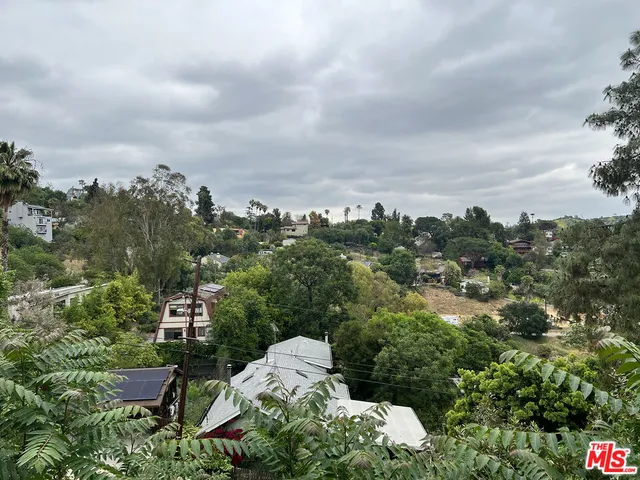 an aerial view of a house with yard