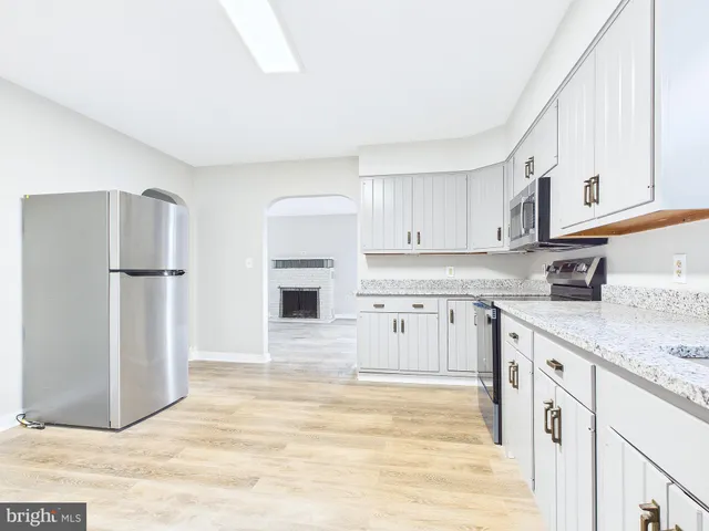 a kitchen with stainless steel appliances granite countertop a refrigerator sink and cabinets