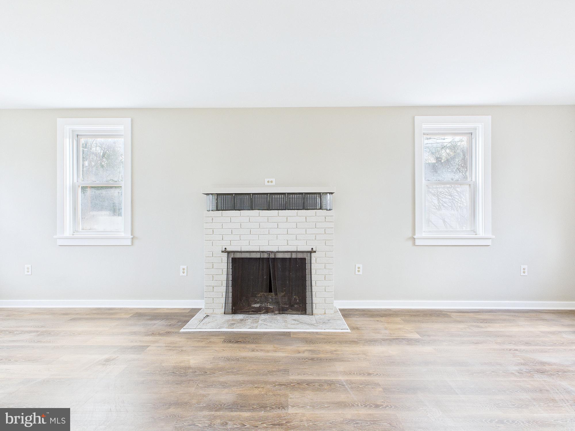 312 Market Street Highspire, PA 17034 - Photo 15 of 38 a view of empty room with wooden floor and fireplace