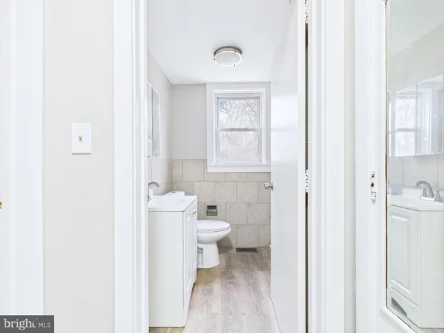 a view of a big room with wooden floor and windows