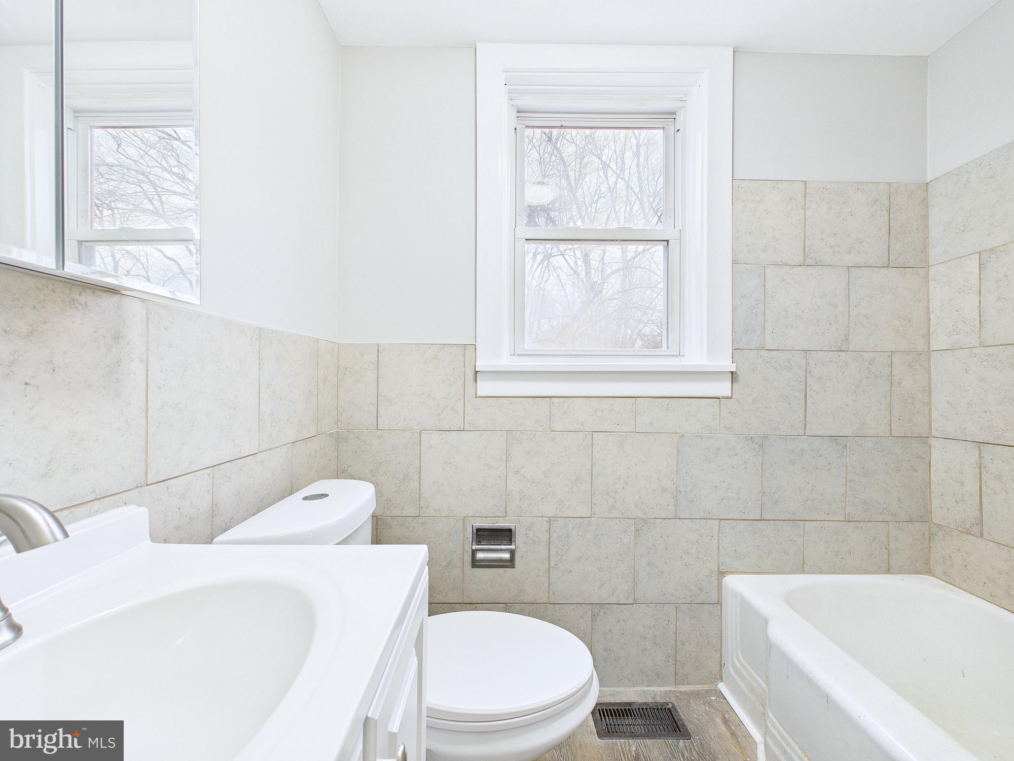 312 Market Street Highspire, PA 17034 - Photo 19 of 38 a bathroom with a sink a toilet and bathtub