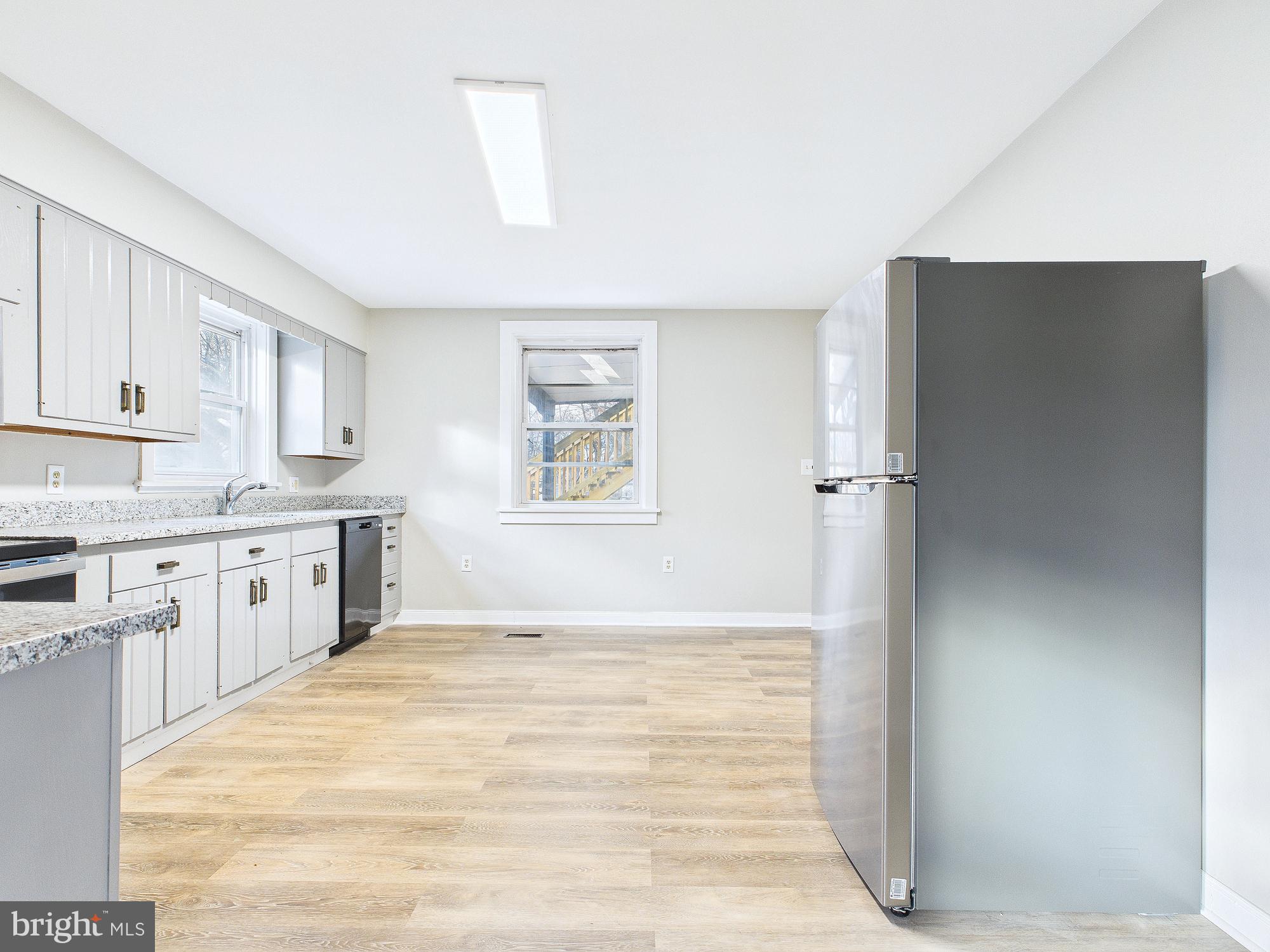 312 Market Street Highspire, PA 17034 - Photo 22 of 38 a large white kitchen with refrigerator stove and a sink
