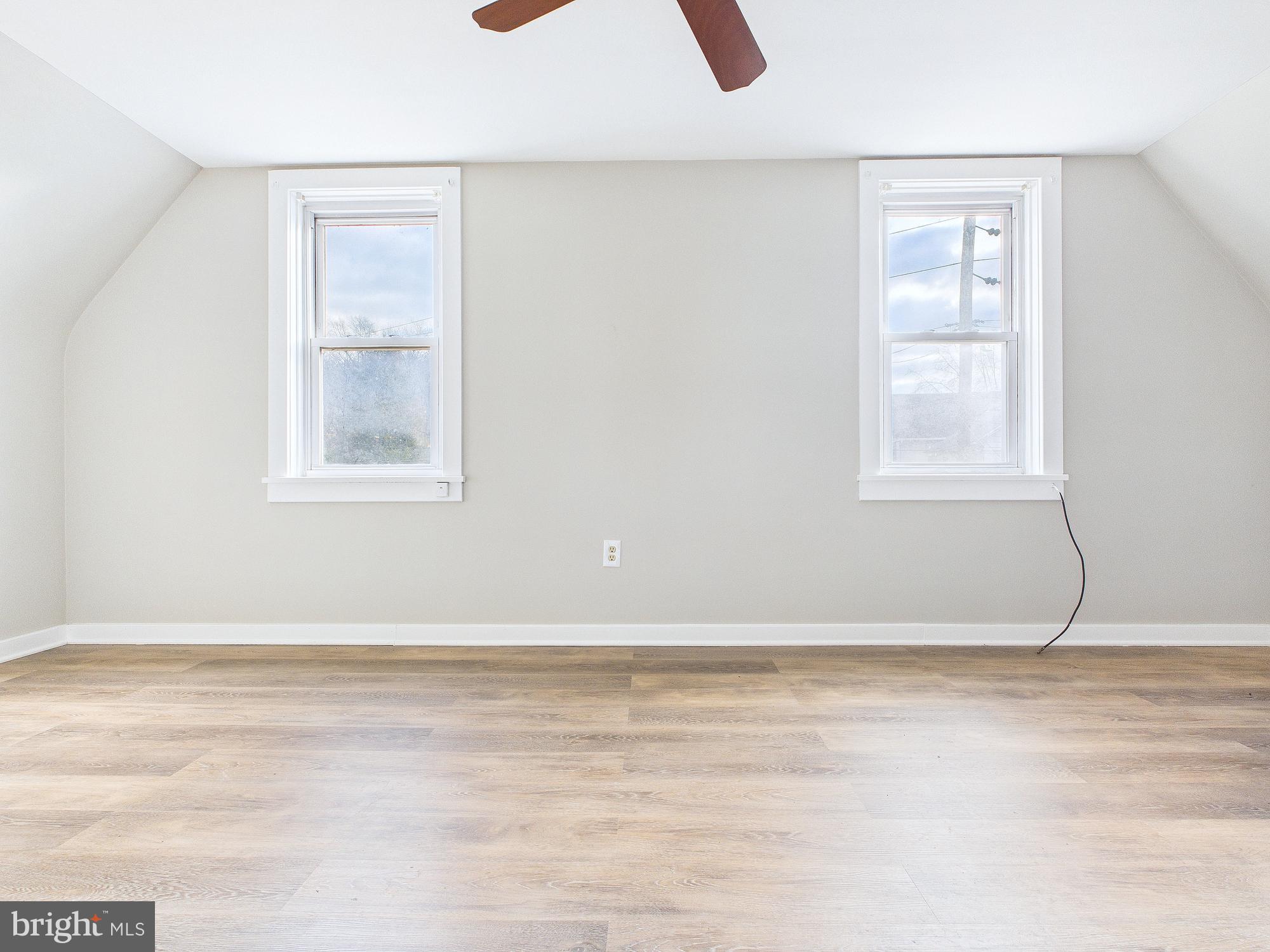 312 Market Street Highspire, PA 17034 - Photo 36 of 38 an empty room with wooden floor and windows